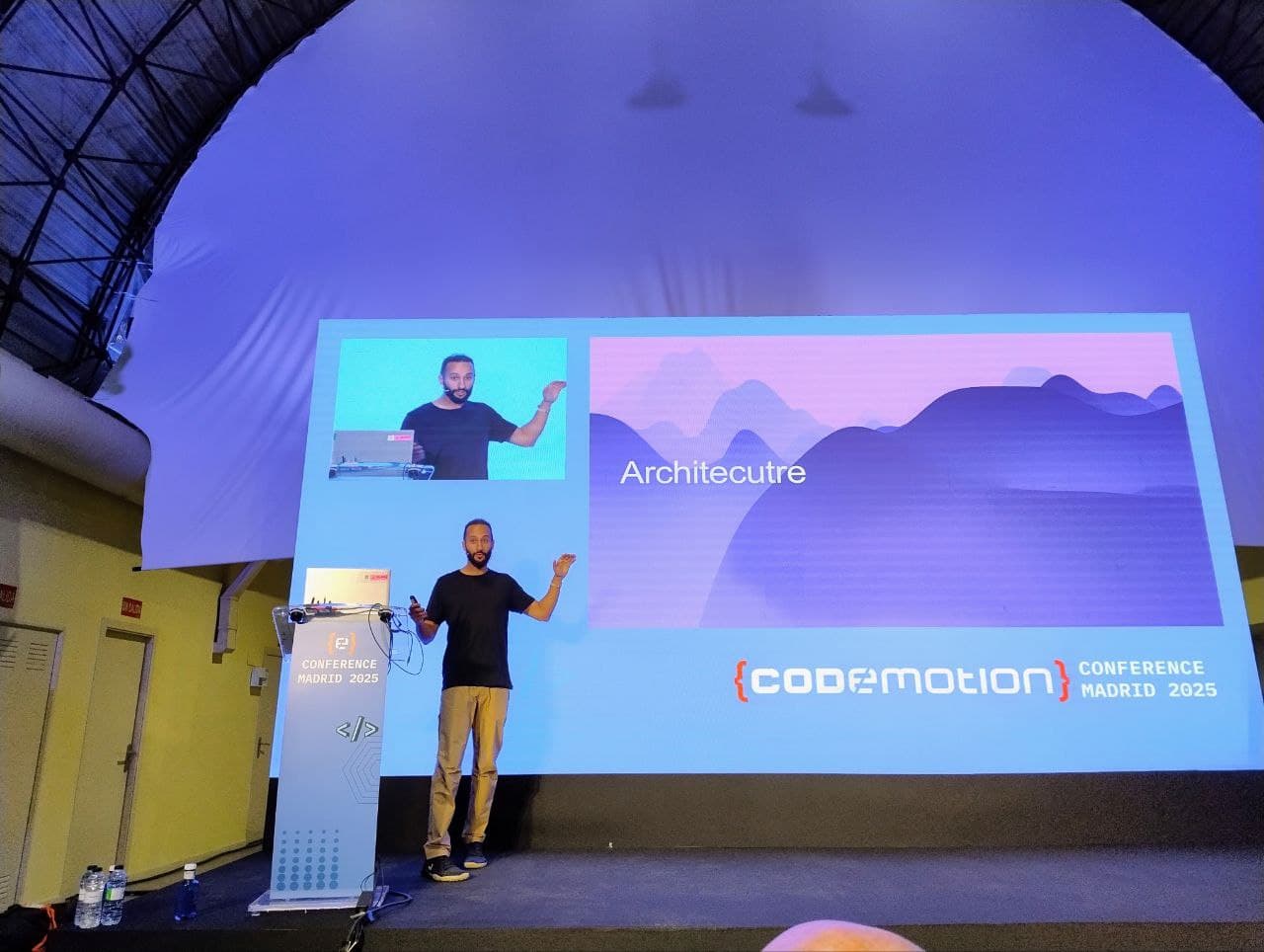 César giving a talk on stage